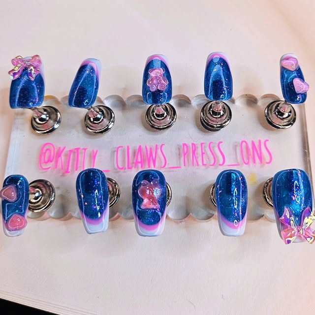 A complete blue and pink Kitty Clawz set arranged for sizing